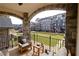 Inviting balcony with stone archways, wrought iron railing, and comfortable seating overlooking a well-manicured lawn at 229 Peachtree Hills Ave # 124, Atlanta, GA 30305