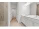 Bright bathroom with double vanity sinks, neutral tile, and a walk-in shower at 385 Riverwood Pass, Dallas, GA 30157