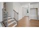 Bright entryway featuring hardwood floors, staircase, and white trim details at 385 Riverwood Pass, Dallas, GA 30157