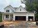 New construction home with a two-car garage with unfinished landscaping at 385 Riverwood Pass, Dallas, GA 30157