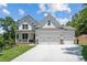 Stunning two-story home with a three-car garage and a well-manicured front yard at 385 Riverwood Pass, Dallas, GA 30157