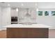 New kitchen boasts stainless appliances, island with sink and seating at 385 Riverwood Pass, Dallas, GA 30157