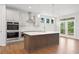 Modern kitchen with stainless appliances, an island, and wood flooring at 385 Riverwood Pass, Dallas, GA 30157