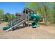 Community playground with wooden structure, slides, and wood chip ground cover at 385 Riverwood Pass, Dallas, GA 30157