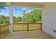 Relaxing porch with wooden railing offering a view of the landscaped backyard at 385 Riverwood Pass, Dallas, GA 30157