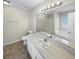 Well-lit bathroom with a large mirror, double sink vanity, and separate tub and shower at 405 Willow Shoals Dr, Covington, GA 30016