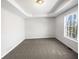 Spacious bedroom with a tray ceiling and large window at 405 Willow Shoals Dr, Covington, GA 30016