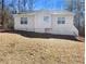 Rear exterior view of the home showcasing a well-maintained yard at 405 Willow Shoals Dr, Covington, GA 30016