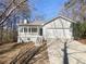 Charming single Gathering home with a covered front porch, two-car garage, and landscaped yard at 405 Willow Shoals Dr, Covington, GA 30016