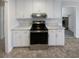 Bright kitchen featuring white cabinets and a stainless steel range at 405 Willow Shoals Dr, Covington, GA 30016