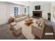 Bright living room with a stone fireplace, plush seating, and large windows at 405 Willow Shoals Dr, Covington, GA 30016