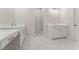 Bright bathroom with double vanity, white cabinets, modern fixtures, and marble tile flooring at 731 Crest Line W Trl, Powder Springs, GA 30127