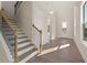 Bright foyer with hardwood floors, a staircase with modern railings, and a view of the entry door at 731 Crest Line W Trl, Powder Springs, GA 30127
