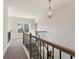 An upstairs hallway with a decorative light fixture and views of the outside at 731 Crest Line W Trl, Powder Springs, GA 30127