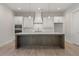 Stylish kitchen with a large center island, stainless steel appliances, and white cabinetry at 731 Crest Line W Trl, Powder Springs, GA 30127