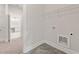 A well-lit laundry room featuring gray tile floors and ample space for appliances at 731 Crest Line W Trl, Powder Springs, GA 30127
