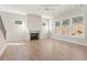 Bright living room with hardwood floors, a modern fireplace, and large windows offering a scenic view at 731 Crest Line W Trl, Powder Springs, GA 30127