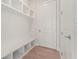 Bright mudroom with white shelving, beadboard, and bench seating for convenient storage at 731 Crest Line W Trl, Powder Springs, GA 30127