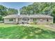 Spacious backyard featuring a combination of siding and stone exteriors with a large lawn at 1110 Asbury St, Oxford, GA 30054