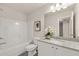 This is a full bathroom featuring granite counters, new fixtures, and a white tub surround at 228 Epping Street # 8, Stockbridge, GA 30281