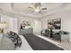 This is a bedroom with a ceiling fan, tray ceiling, and gray walls with 2 chairs at 228 Epping Street # 8, Stockbridge, GA 30281