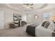 This is a bedroom with neutral decor, carpet, two chairs, and a ceiling fan with tray ceilings at 228 Epping Street # 8, Stockbridge, GA 30281