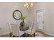 Cozy dining area with modern chandelier, and table with seating for four creates an inviting space for meals at 228 Epping Street # 8, Stockbridge, GA 30281