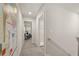 Upstairs hallway with carpet, art, and a view to a seating area creates a serene and inviting atmosphere at 228 Epping Street # 8, Stockbridge, GA 30281