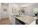 Kitchen island features a sink, stainless steel dishwasher, and granite countertops for ample cooking space at 228 Epping Street # 8, Stockbridge, GA 30281