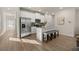 Open-concept kitchen with a kitchen island, stainless steel appliances, and wood flooring enhance the home's modern appeal at 228 Epping Street # 8, Stockbridge, GA 30281