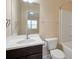Neutral bathroom featuring a sleek vanity, framed mirror, and a combined shower-tub at 6650 Canyon Cv, Cumming, GA 30028