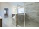 Elegant bathroom showcasing a glass-enclosed shower and a luxurious tiled tub surround at 6650 Canyon Cv, Cumming, GA 30028