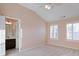 This bright bedroom features large windows, vaulted ceiling, and an ensuite bathroom at 6650 Canyon Cv, Cumming, GA 30028