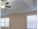 Large bedroom with tray ceiling and two windows at 6650 Canyon Cv, Cumming, GA 30028