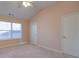 Bedroom featuring plush carpet, a double door closet, and a large window providing natural light at 6650 Canyon Cv, Cumming, GA 30028