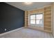 Bedroom with a large window, built-in cabinets, and shelving at 6650 Canyon Cv, Cumming, GA 30028