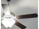 Ceiling fan with dark blades and a light fixture at 6650 Canyon Cv, Cumming, GA 30028
