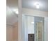 Hallway featuring a view into walk-in closets with shelving, and views of the bathroom at 6650 Canyon Cv, Cumming, GA 30028