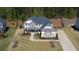 Overhead view of a charming two-story home with a long driveway and beautiful landscaping at 6650 Canyon Cv, Cumming, GA 30028