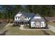Beautiful two-story home featuring stone accents, a welcoming front porch, and a well-maintained landscaped yard at 6650 Canyon Cv, Cumming, GA 30028