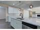 Bright kitchen has a large island with stainless steel appliances and a view of the living room at 6650 Canyon Cv, Cumming, GA 30028