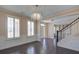 Elegant living room with hardwood floors, plantation shutters, and decorative wainscoting at 6650 Canyon Cv, Cumming, GA 30028