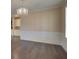 Bright and airy living room showcasing wainscoting, a modern chandelier, and dark hardwood floors at 6650 Canyon Cv, Cumming, GA 30028