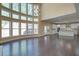 Open concept living room boasting soaring windows, an open layout, and hardwood floors at 6650 Canyon Cv, Cumming, GA 30028