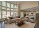 Open concept living room boasting soaring windows, an open layout, and hardwood floors at 6650 Canyon Cv, Cumming, GA 30028