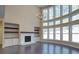 Open concept living room boasting soaring windows, an open layout, and hardwood floors at 6650 Canyon Cv, Cumming, GA 30028