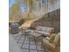 Outdoor patio area with grill, seating, and mature trees surrounding a lush green lawn at 6650 Canyon Cv, Cumming, GA 30028