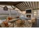 This furnished sunroom features a brick fireplace, vaulted ceiling, and walls of windows at 6650 Canyon Cv, Cumming, GA 30028