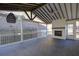 Spacious sunroom featuring a brick fireplace, vaulted ceiling, and walls of windows at 6650 Canyon Cv, Cumming, GA 30028
