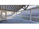 Open-air sunroom with beamed ceiling and walls of windows overlooking a private yard at 6650 Canyon Cv, Cumming, GA 30028
